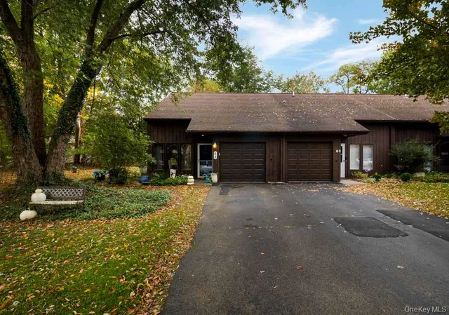 a front view of a house with a yard and a garage