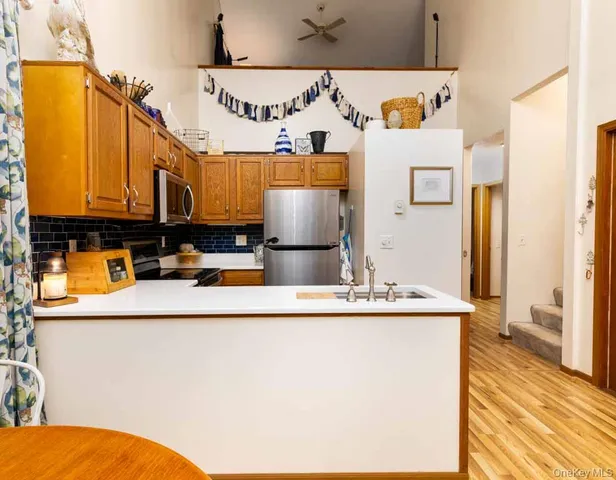a kitchen with stainless steel appliances granite countertop a sink and a refrigerator