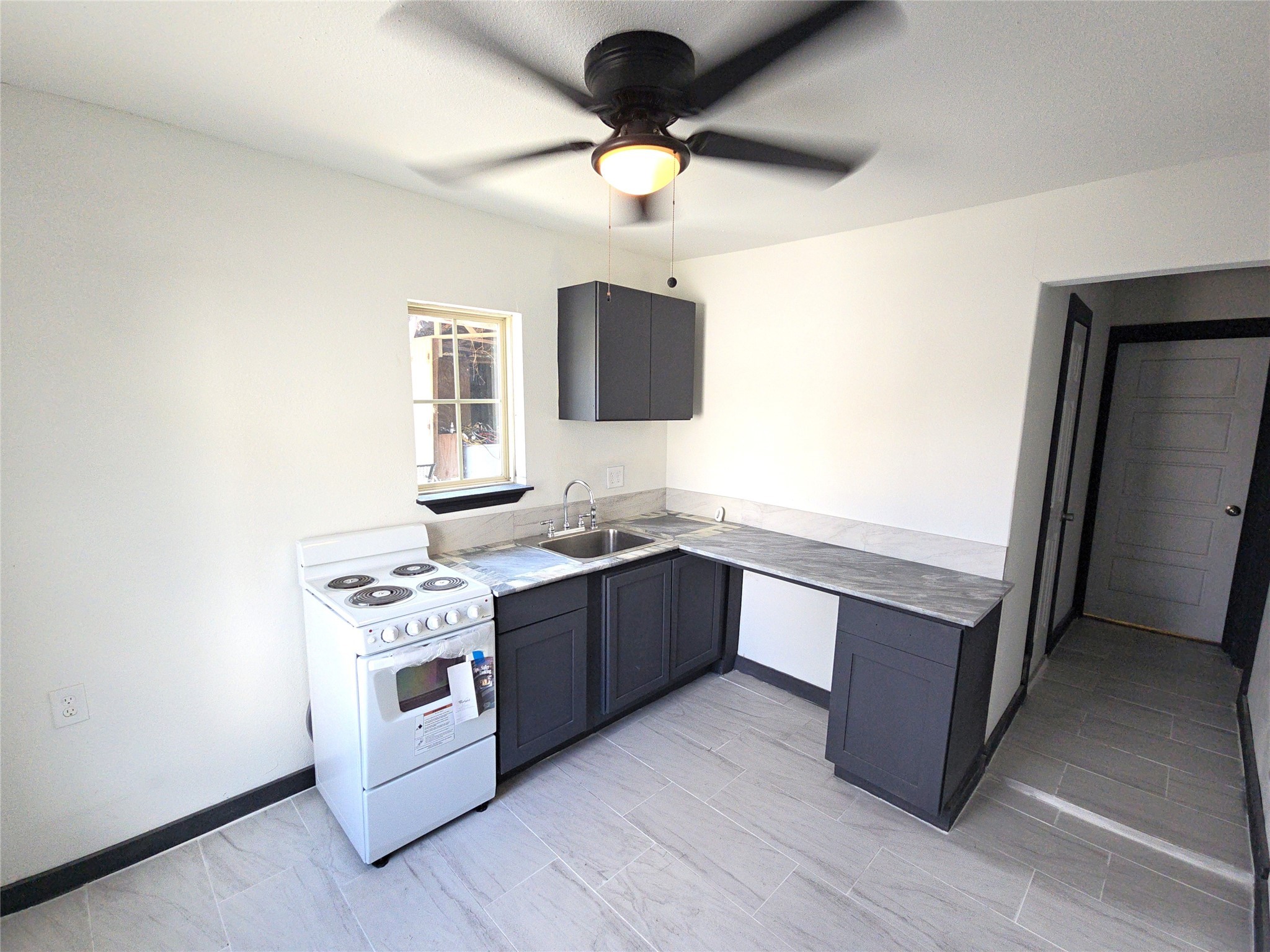 a kitchen with stainless steel appliances a stove a microwave and a hard wood floor