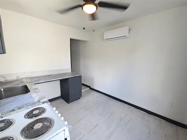 a kitchen with a refrigerator and stove