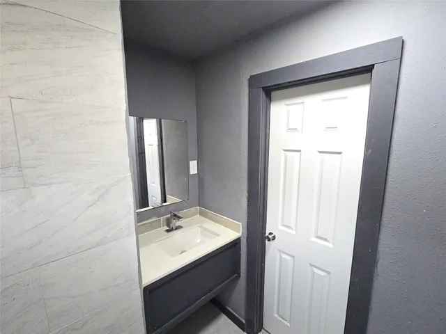 a bathroom with a sink a mirror and a vanity