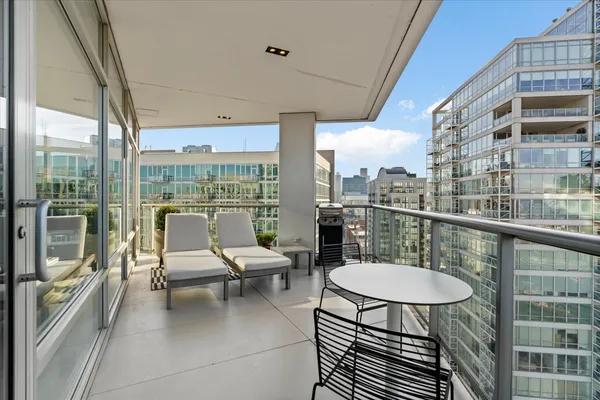 a balcony view with a seating space