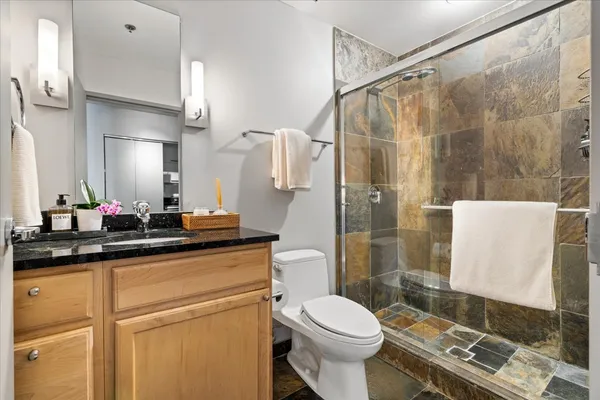 a bathroom with a sink a toilet and shower