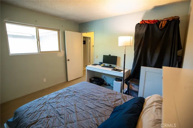 a bedroom with a bed and a desk