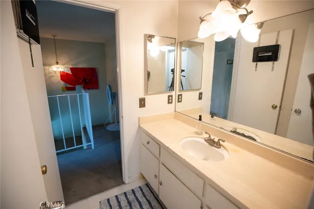 a bathroom with a sink a toilet and a mirror