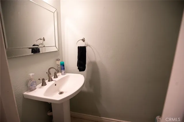 a white toilet sitting in a bathroom next to a sink