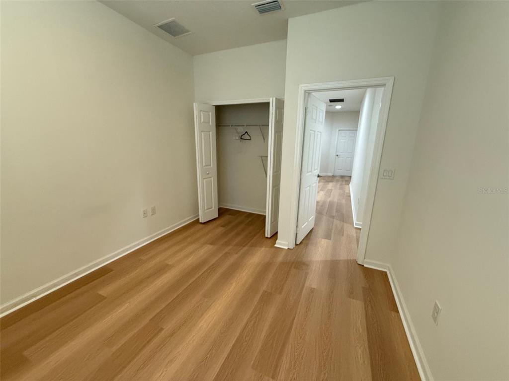 1766 Portofino Meadows Boulevard Orlando, FL 32824 - Photo 16 of 20 a view of a hallway with wooden floor