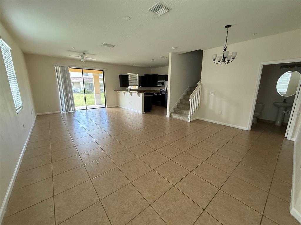1766 Portofino Meadows Boulevard Orlando, FL 32824 - Photo 5 of 20 a view of a livingroom with furniture wooden floor and window