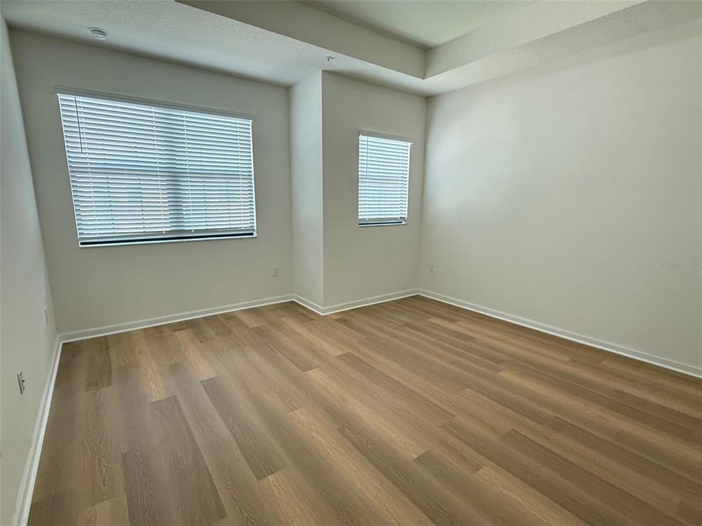 1766 Portofino Meadows Boulevard Orlando, FL 32824 - Photo 8 of 20 a view of empty room with wooden floor and fan
