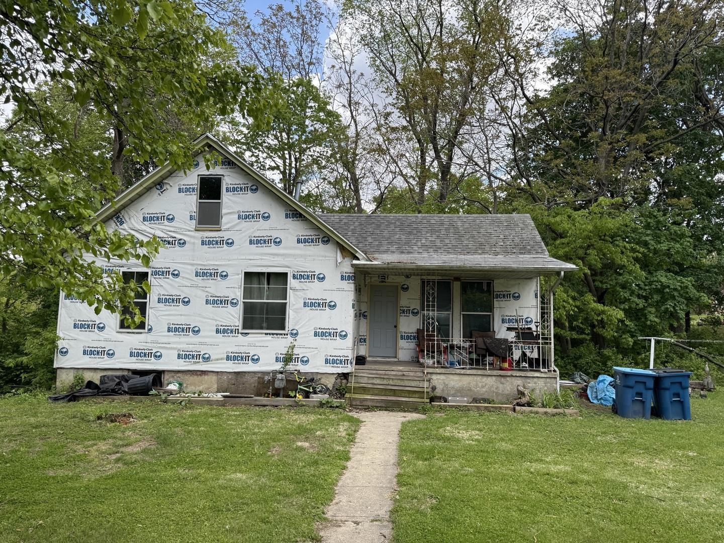 a view of a house with a yard porch and sitting area