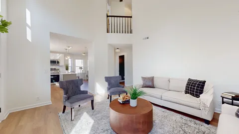 a living room with furniture potted plant and a window