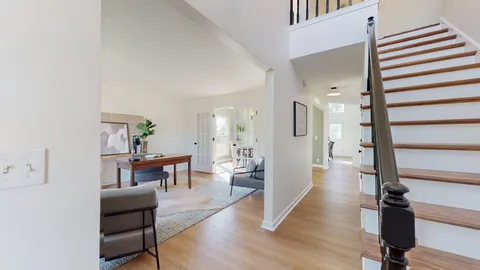 a view of a livingroom with furniture and hardwood floor