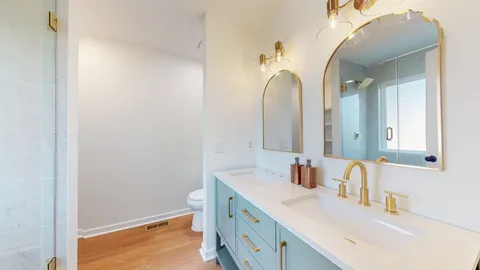 a bathroom with a sink vanity and a mirror