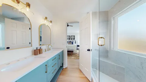 a bathroom with double vanity sink and mirror