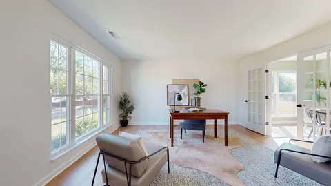 a living room with furniture a table and a large window