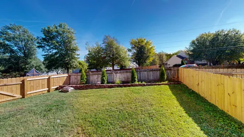 a view of a house with pool and yard