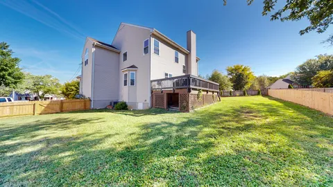 a backyard of a house with lots of green space and fountain