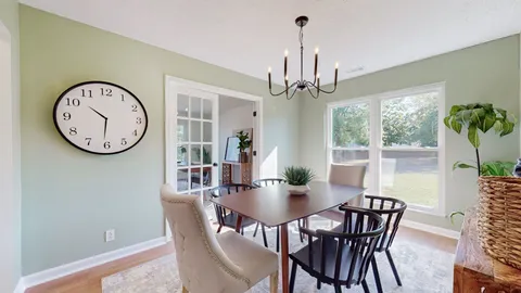 a view of a dining room with furniture window and wooden floor