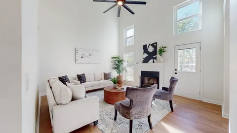 a living room with furniture a fireplace and a potted plant