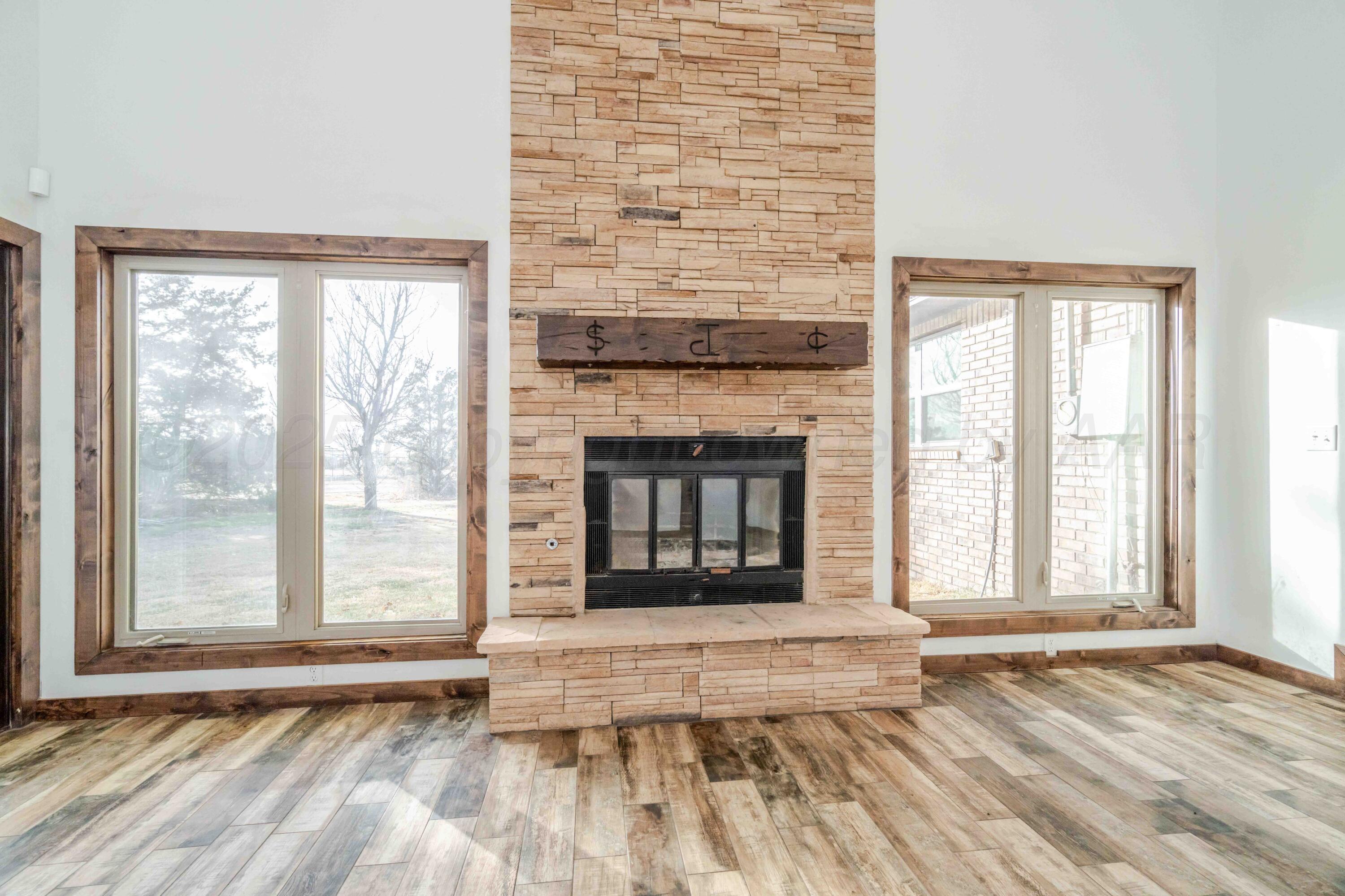 5490 West Rd R Dumas, TX 79029 - Photo 13 of 36 a view of an empty room with wooden floor and a window