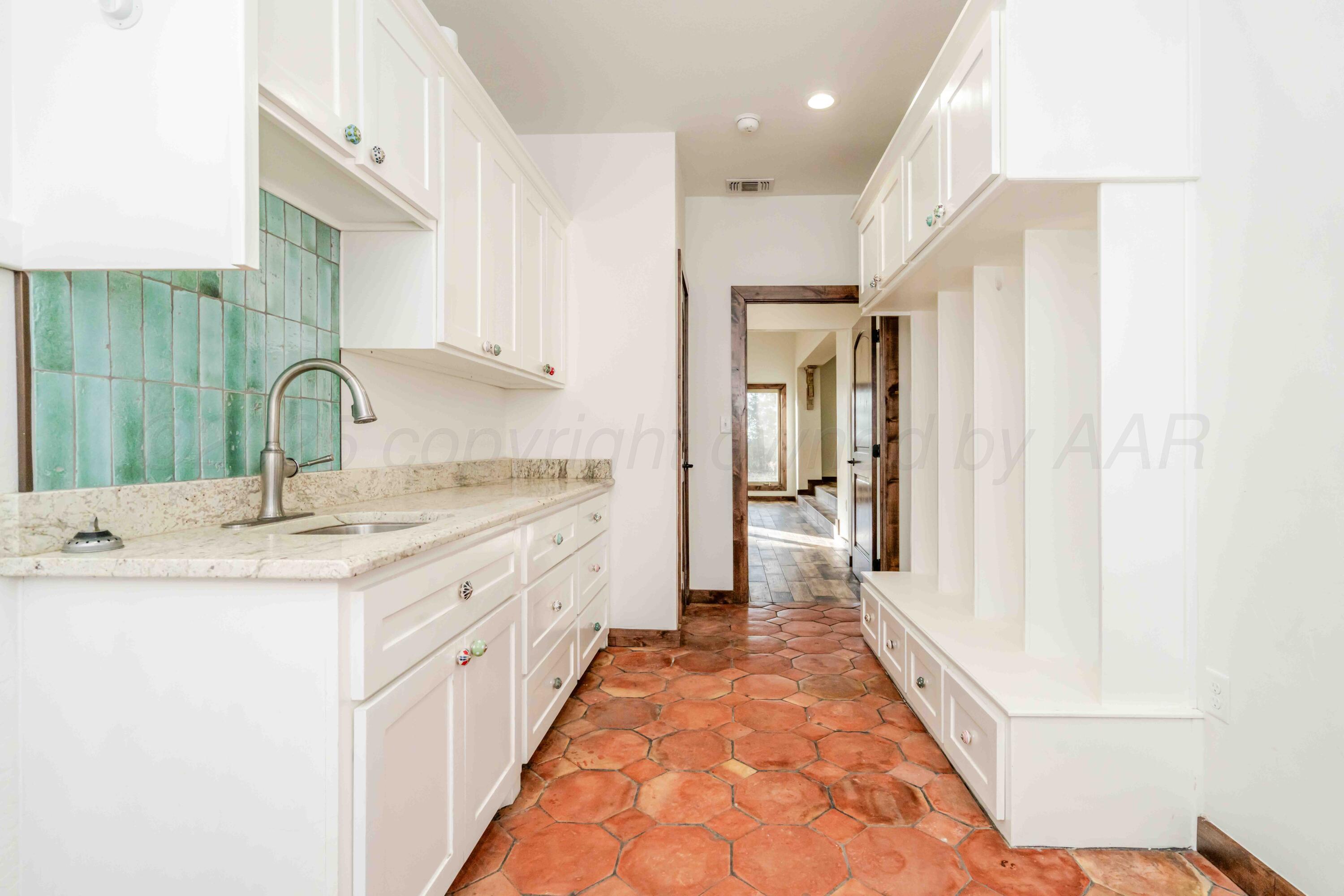 5490 West Rd R Dumas, TX 79029 - Photo 15 of 36 a bathroom with a double vanity sink and mirror