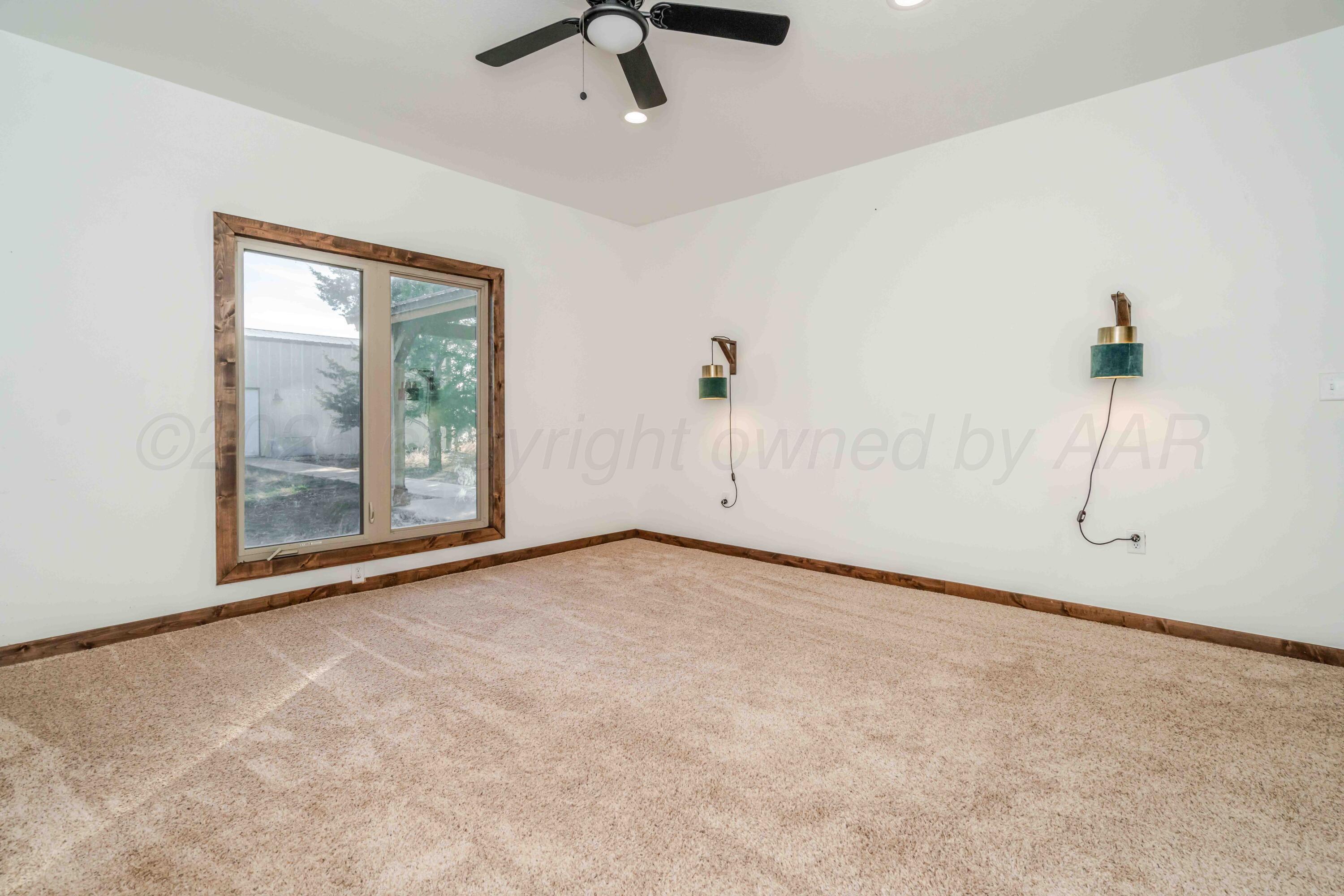 5490 West Rd R Dumas, TX 79029 - Photo 16 of 36 an empty room with fan