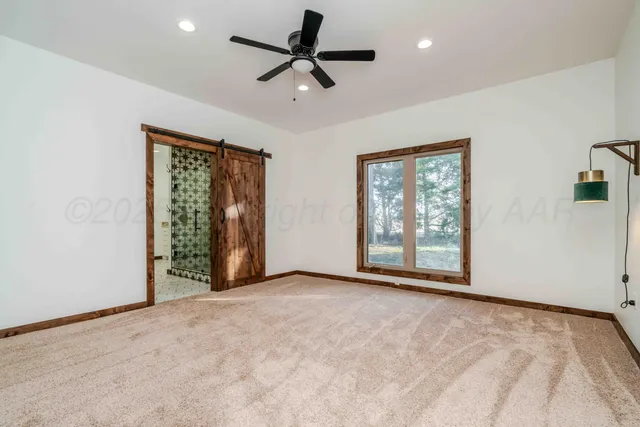 a bathroom with a toilet and a shower curtain