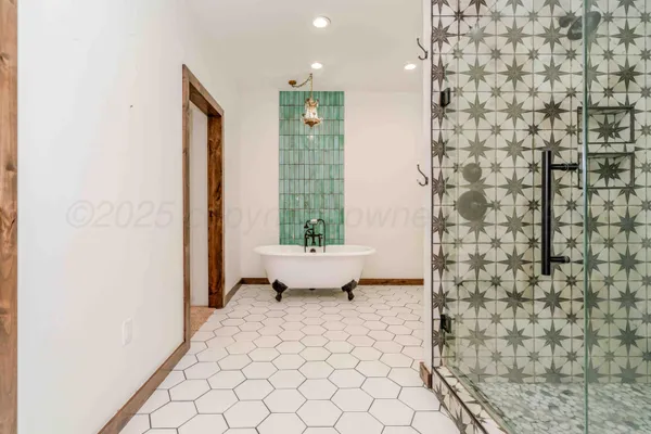 a bathroom with a granite countertop sink mirror and shower