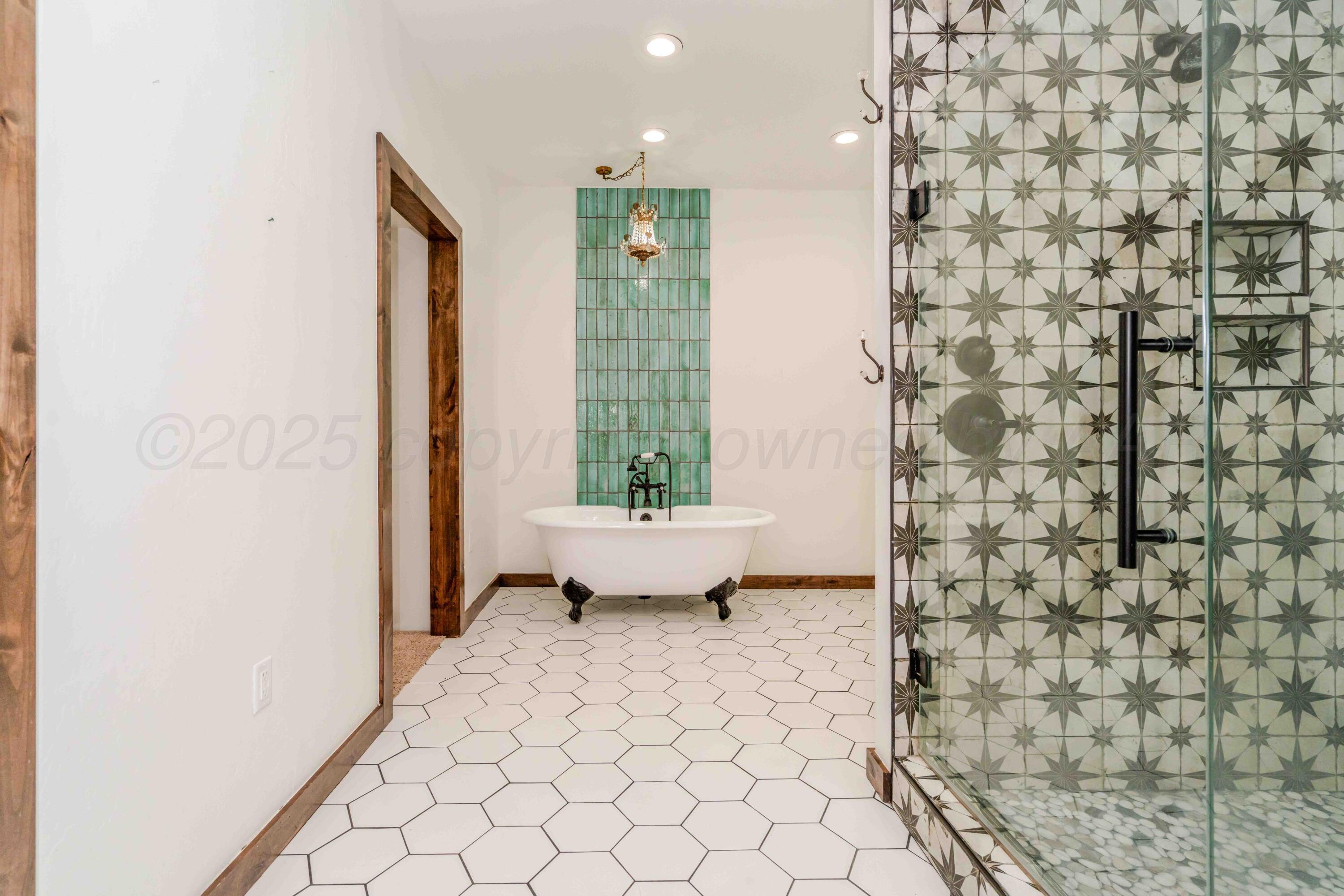 5490 West Rd R Dumas, TX 79029 - Photo 18 of 36 a bathroom with a toilet and a shower curtain