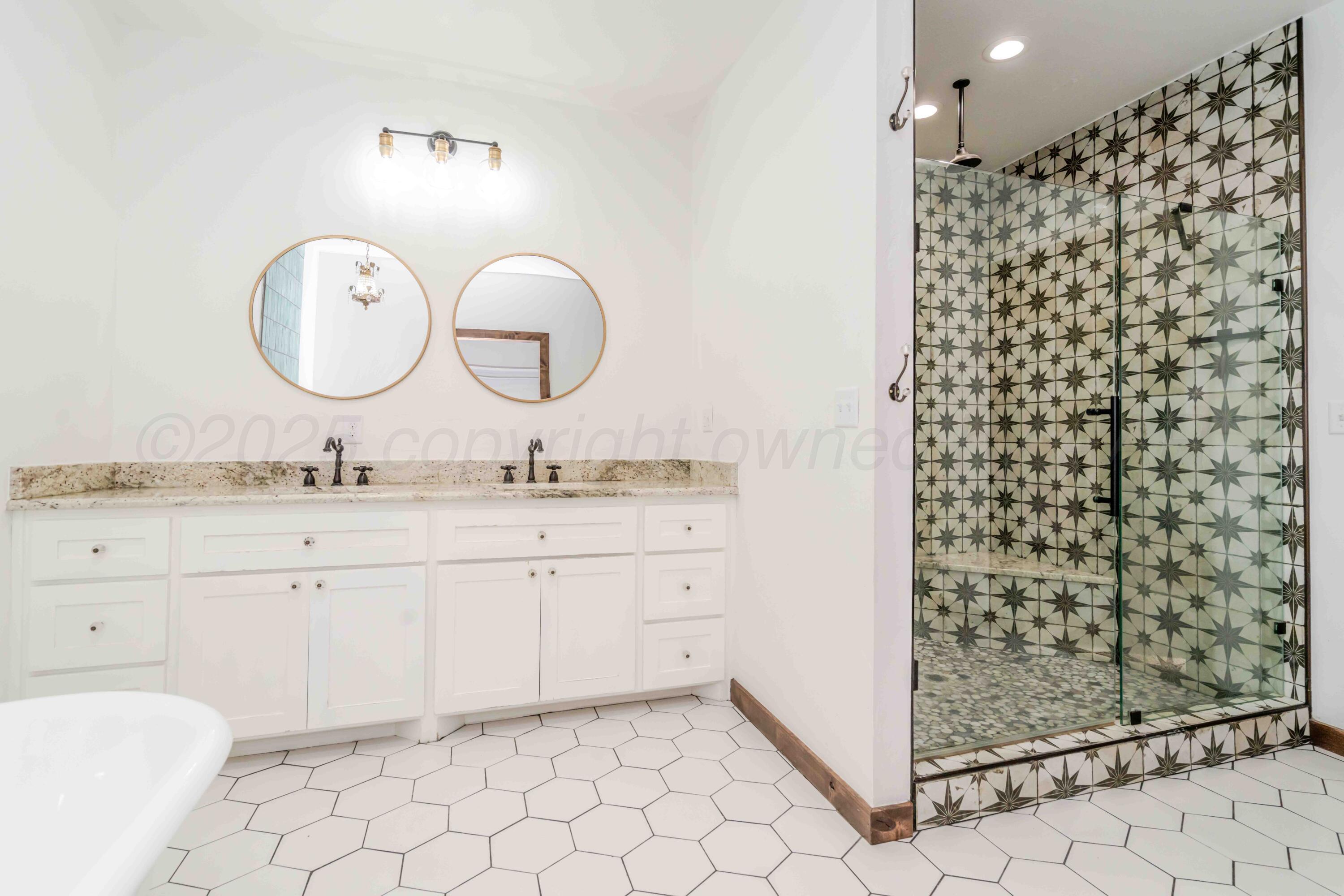 5490 West Rd R Dumas, TX 79029 - Photo 19 of 36 a bathroom with a granite countertop sink mirror and shower