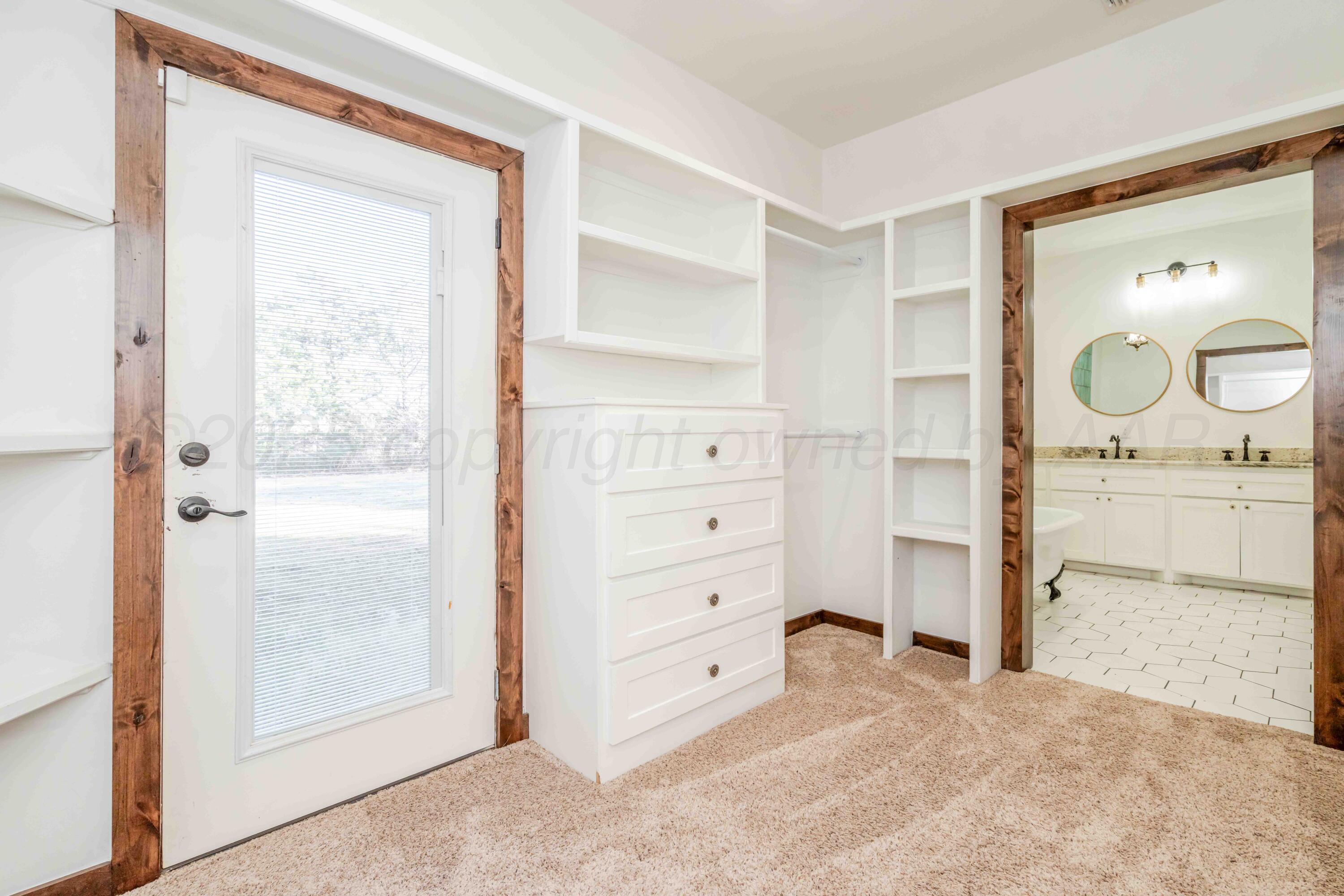5490 West Rd R Dumas, TX 79029 - Photo 23 of 36 a view of a bedroom with cabinet and mirror