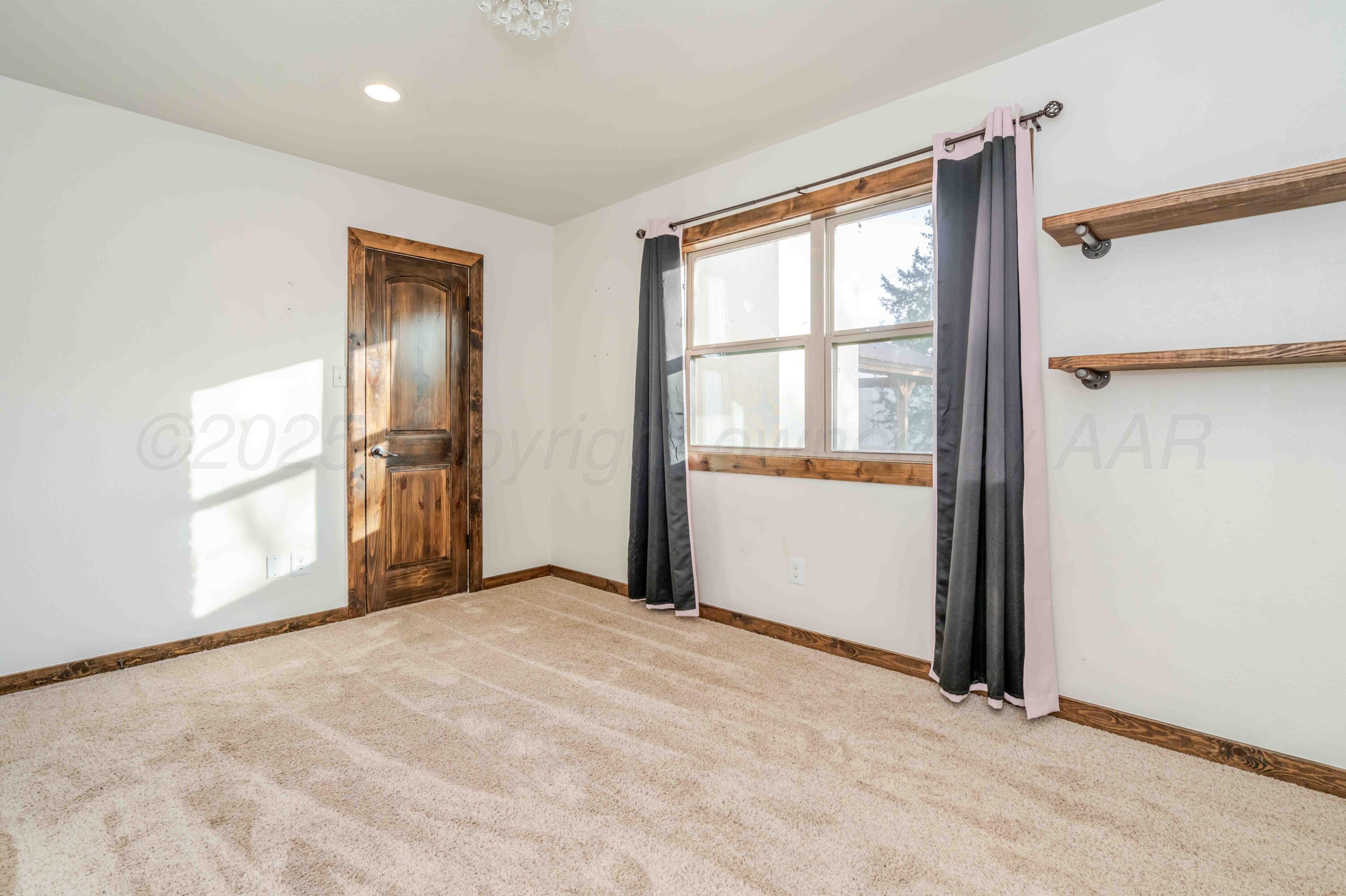 5490 West Rd R Dumas, TX 79029 - Photo 27 of 36 an empty room with windows