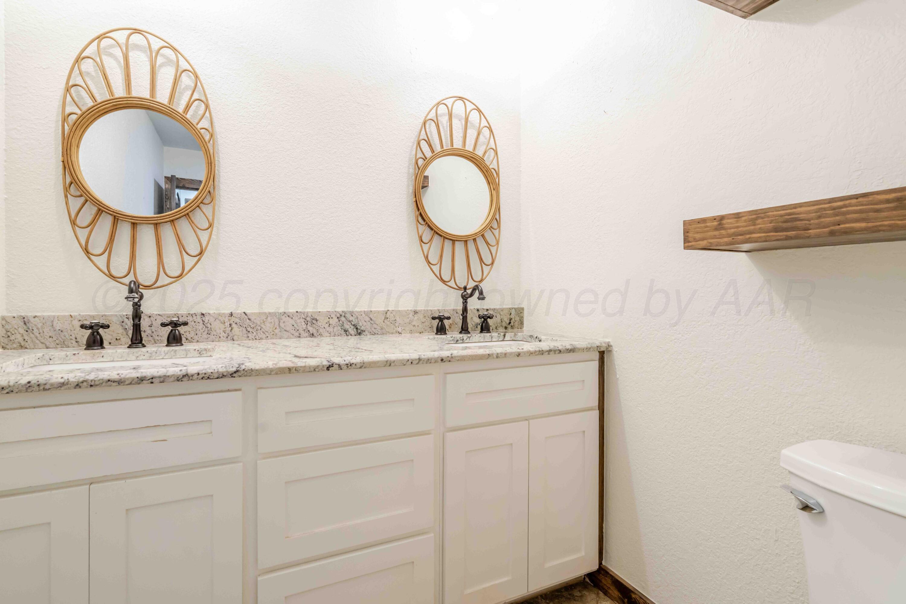 5490 West Rd R Dumas, TX 79029 - Photo 28 of 36 a bathroom with a granite countertop double vanity sink and a mirror