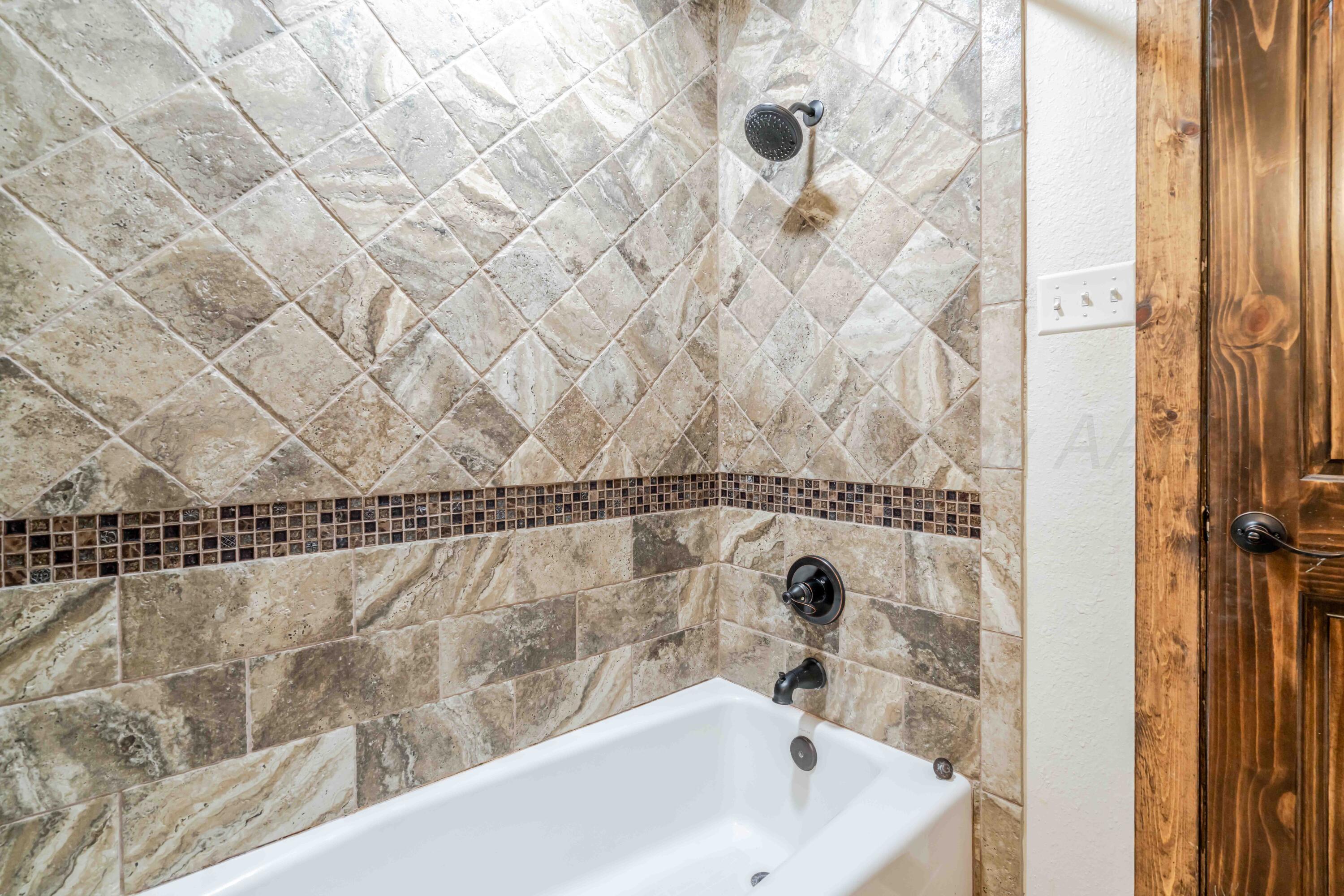 5490 West Rd R Dumas, TX 79029 - Photo 29 of 36 a bathroom with a bathtub and shower