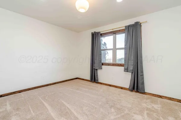 a view of a house with backyard and trees