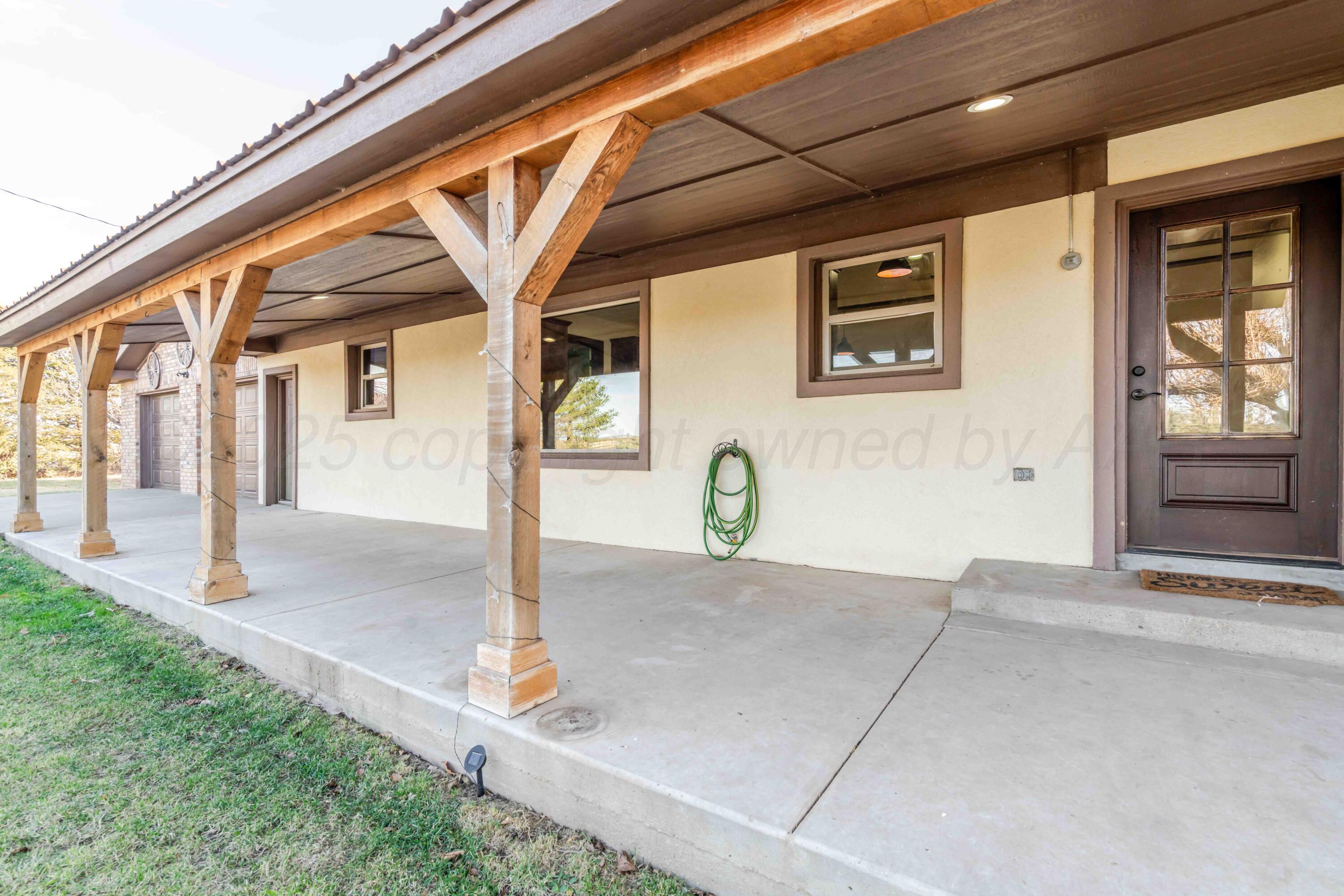 5490 West Rd R Dumas, TX 79029 - Photo 3 of 36 a front view of a house with parking area