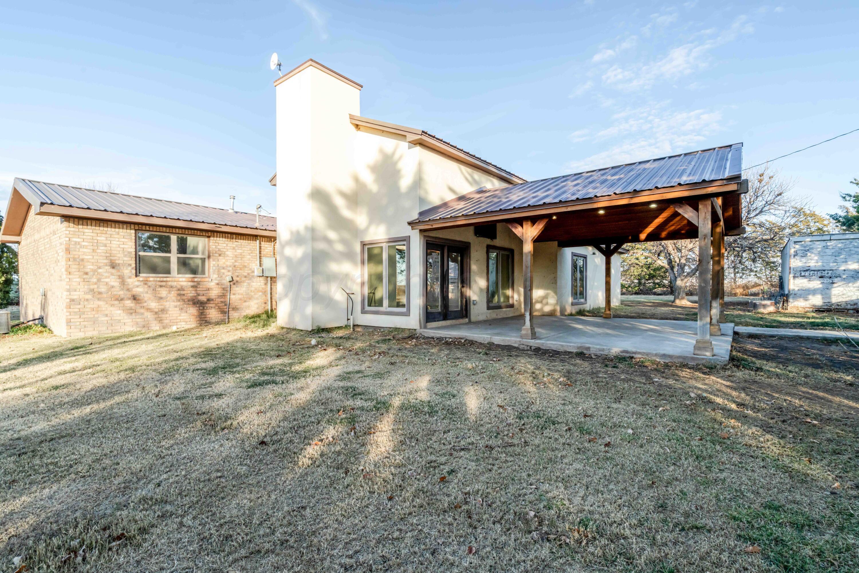 5490 West Rd R Dumas, TX 79029 - Photo 31 of 36 a view of a house with backyard and trees
