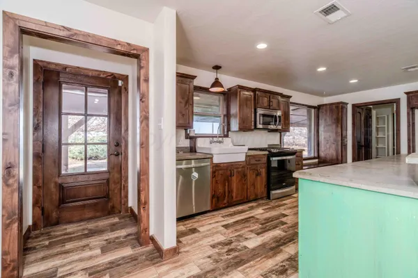 a kitchen with refrigerator and cabinets
