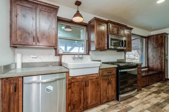 a kitchen with stainless steel appliances granite countertop a stove microwave and cabinets
