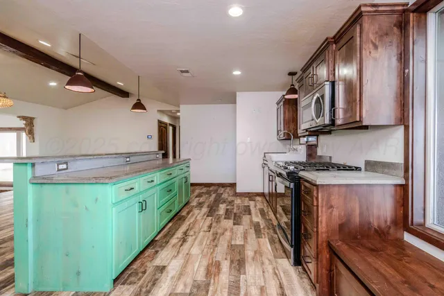 a kitchen with stainless steel appliances granite countertop a stove and a sink