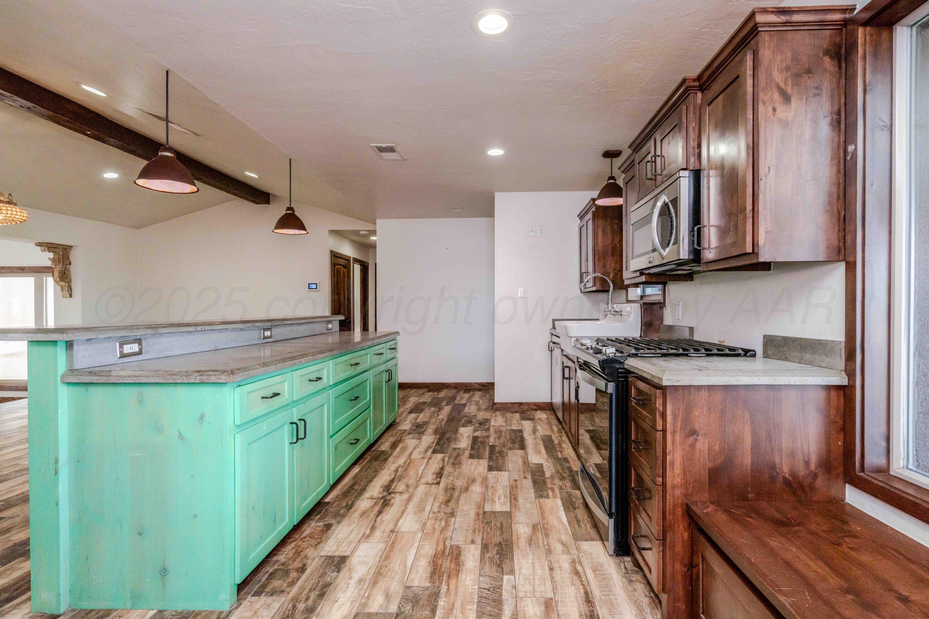 5490 West Rd R Dumas, TX 79029 - Photo 7 of 36 a kitchen with stainless steel appliances granite countertop a stove and a sink