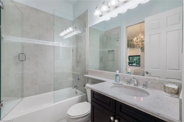 a bathroom with a granite countertop sink a mirror and a shower
