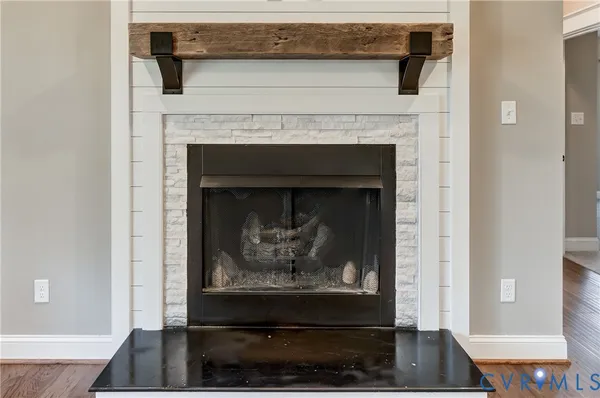 an open kitchen with wooden floor and stainless steel appliances