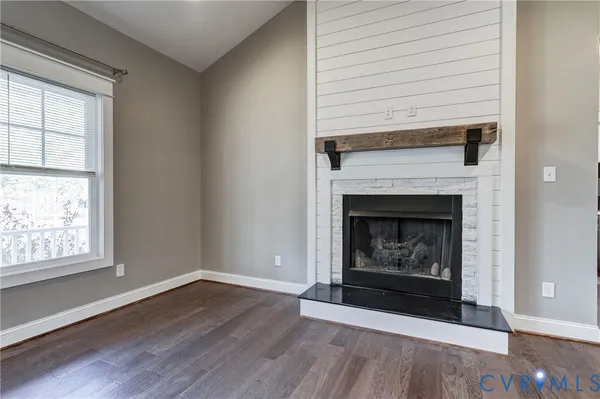 a kitchen with stainless steel appliances granite countertop a sink a stove a refrigerator and white cabinets