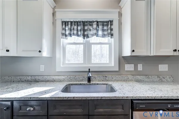 a view of a kitchen with a sink and a large window