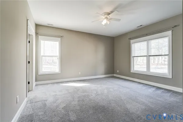 a bathroom with a bathtub shower sink mirror and toilet