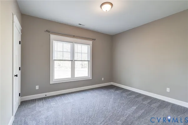 a view of a hallway with wooden floor and closet area