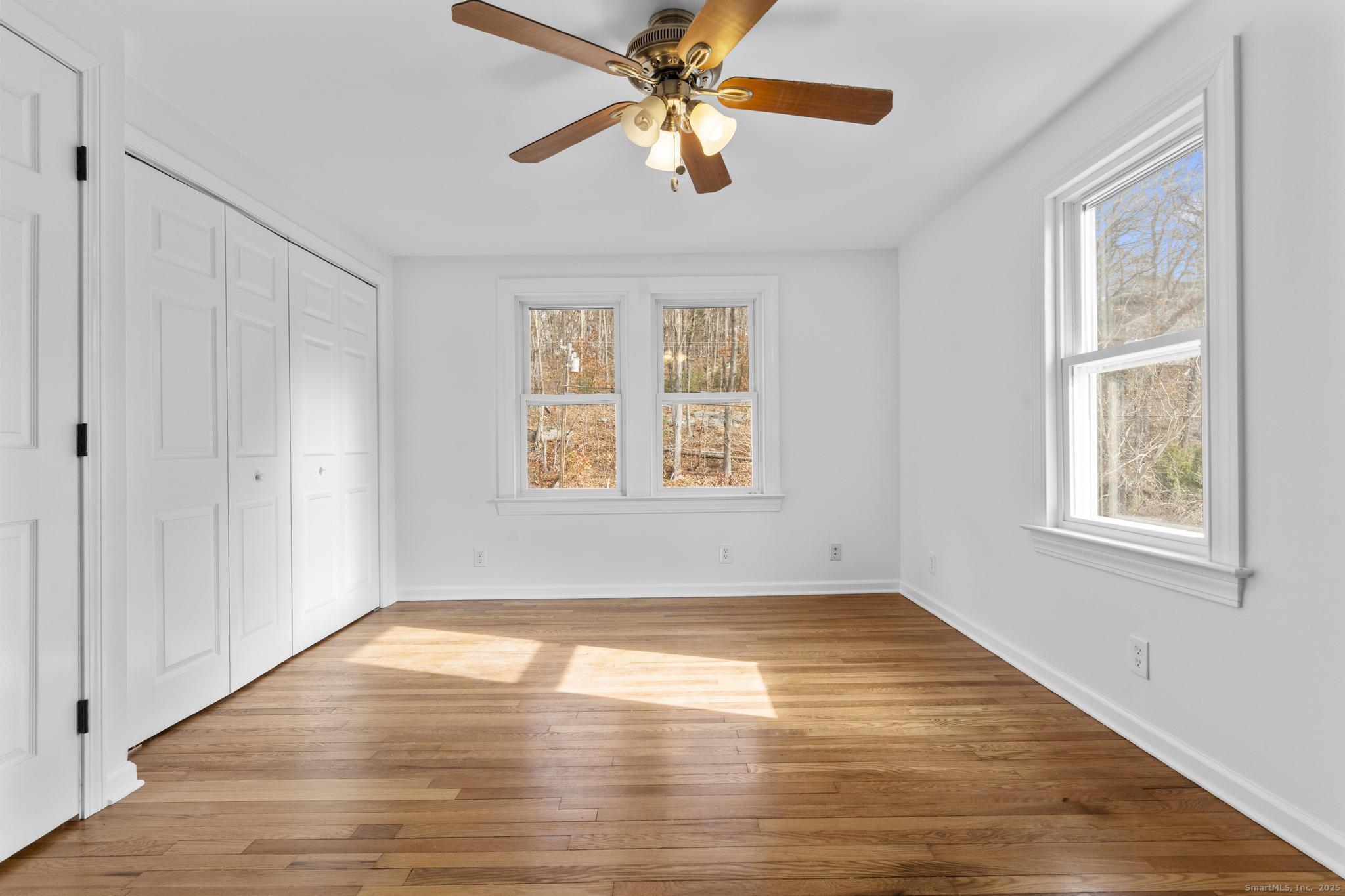 1092 Durham Road Guilford, CT 06437 - Photo 13 of 38 a view of empty room with wooden floor and fan