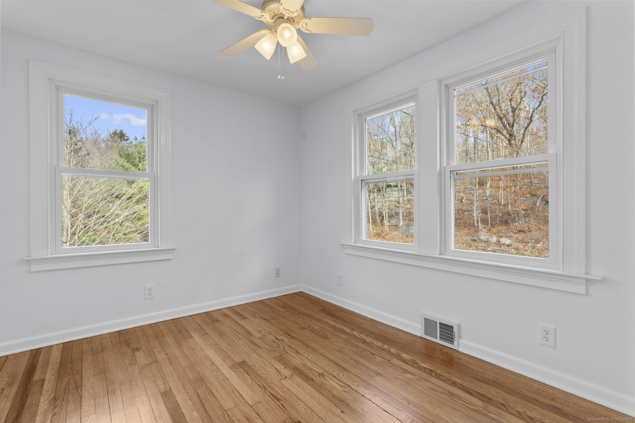 1092 Durham Road Guilford, CT 06437 - Photo 14 of 38 a view of an empty room with wooden floor and a window