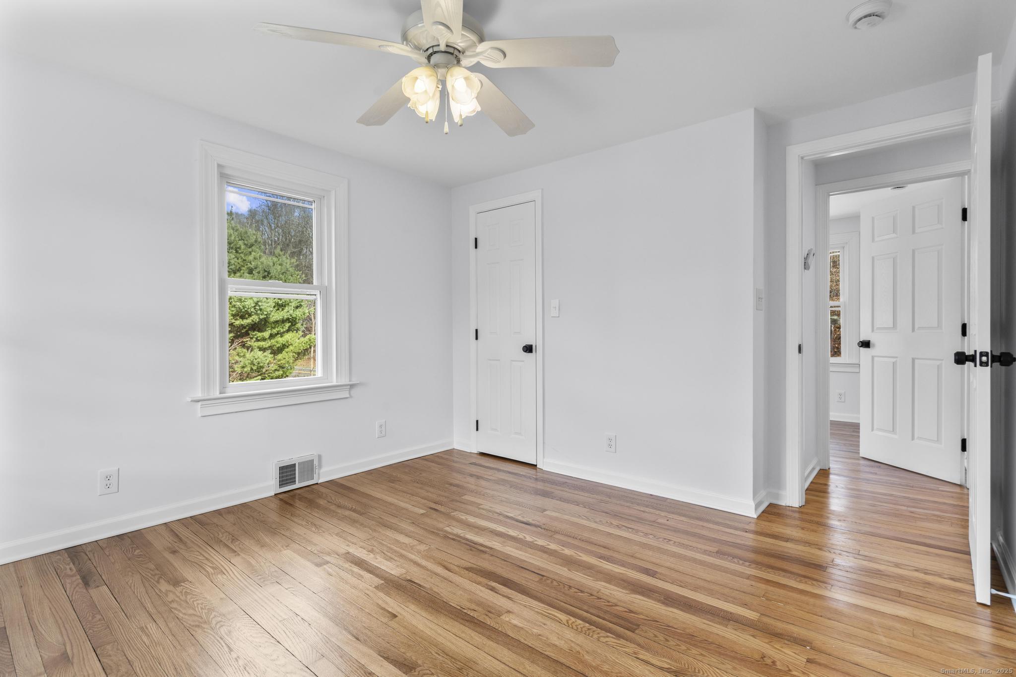1092 Durham Road Guilford, CT 06437 - Photo 15 of 38 a view of empty room with wooden floor and fan